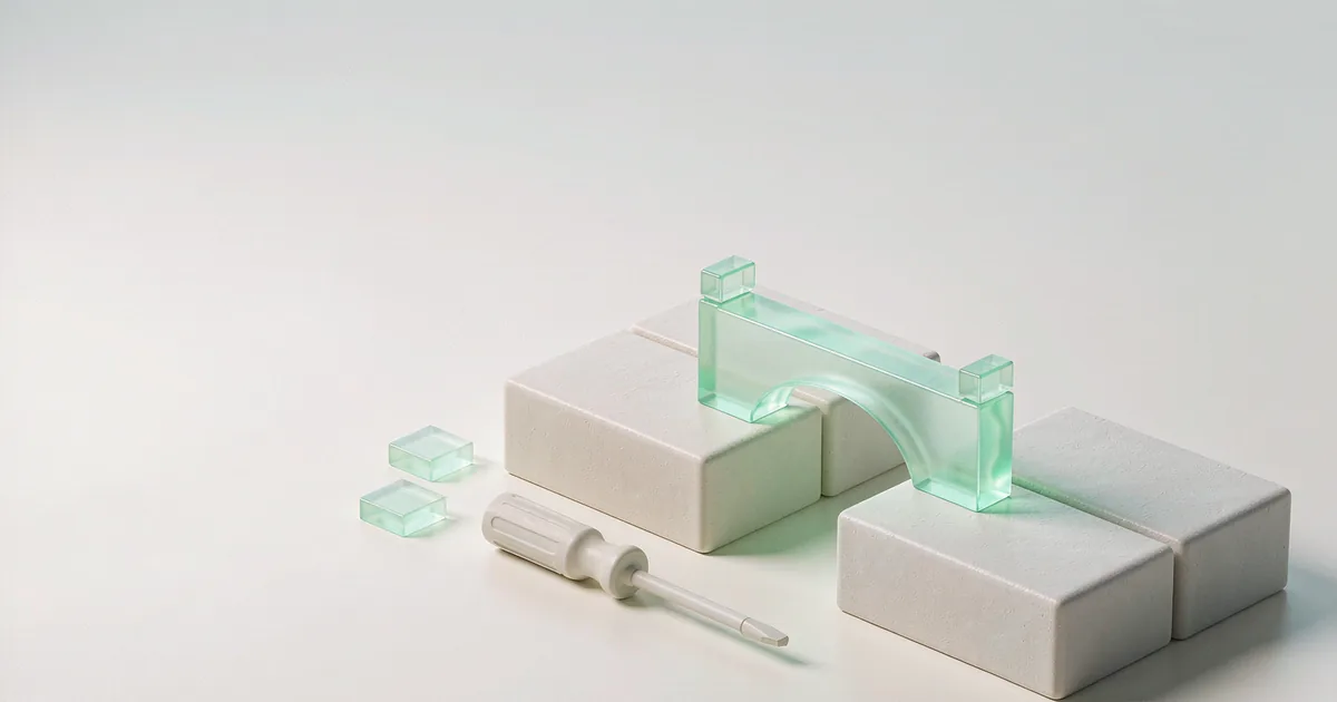 A bright 3D miniature scene: two matte cream-white plaster blocks standing side by side, joined by a low-saturation mint-green translucent glass bridge piece laid across both, a small plaster screwdriver resting diagonally beside them, two mint-green glass squares on the ground, against a cool light grey-white backdrop
